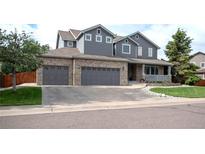 Charming two-story home featuring a three-car garage and a welcoming front porch at 14962 Williams St, Thornton, CO 80602