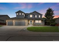 Charming two-story home with a well-manicured lawn and three-car garage at 14962 Williams St, Thornton, CO 80602