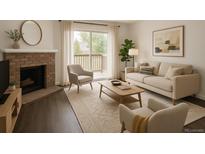 Bright living room features a brick fireplace, balcony access, and comfortable seating at 14500 E 2Nd Ave # 209A, Aurora, CO 80011