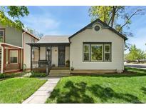 Charming home featuring a front porch, well-maintained lawn and inviting curb appeal at 300 E Cleveland St, Lafayette, CO 80026