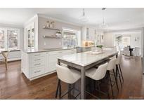 Bright, updated kitchen featuring a marble island and hardwood floors at 2134 S Jackson St, Denver, CO 80210