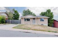 Charming single-story home featuring a well-maintained lawn and a classic brick facade at 230 W 78Th Pl, Denver, CO 80221