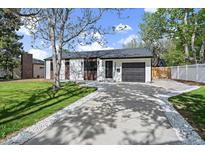 Charming single-story home with a well-maintained front yard and a private driveway to a one car garage at 1360 S Forest Way, Denver, CO 80222