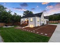 White brick home with landscaped yard, large driveway and a detached garage at 3360 Broadway St, Boulder, CO 80304