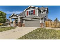 Charming two-story home featuring a two-car garage and a well-maintained lawn and a beautiful front porch at 1488 N Stratton Ave, Castle Rock, CO 80104