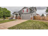Charming two-story home featuring a gray exterior, red shutters, and well-maintained landscaping in a desirable neighborhood at 1488 N Stratton Ave, Castle Rock, CO 80104