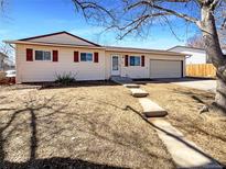 Charming single-story home featuring a well-maintained lawn and attached garage at 15850 E Utah Pl, Aurora, CO 80017