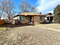 Brick ranch home with a spacious yard and well-maintained landscaping at 3541 Eudora St, Denver, CO 80207