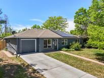 Charming single-story home with painted brick, attached garage, and well-maintained lawn at 971 Ursula St, Aurora, CO 80011