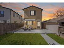 Charming home with a manicured front yard, patio seating, and awning, perfect for relaxing and enjoying the outdoors at 1343 Valentia St, Denver, CO 80220