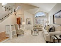 Bright living room featuring vaulted ceilings, large windows, neutral tones, and comfortable seating at 8101 E Dartmouth Ave # 22, Denver, CO 80231