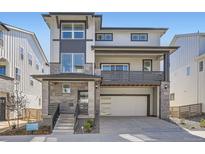 Two-story home featuring a contemporary facade, large windows, and a convenient two-car garage at 7171 Waterleaf Trl, Littleton, CO 80125