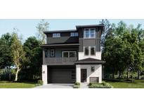 Modern two-story home with a gray and white color scheme, balcony, and an integrated two-car garage at 7171 Waterleaf Trl, Littleton, CO 80125