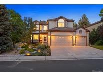 Charming two-story home with landscaped front yard and three-car garage, perfect for Gathering living at 7114 S Acoma Way, Littleton, CO 80120