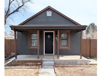 Charming single story home with a cozy front porch and stylish dark gray exterior paint at 2092 Elmira St, Aurora, CO 80010
