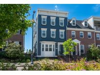 Beautiful three-story home featuring a blue facade with a well-manicured front yard at 10252 E 58Th Ave, Denver, CO 80238