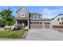 Two-story home with gray siding, stone accents, and a two-car garage at 944 Black Saddle St, Elizabeth, CO 80107