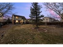 Spacious backyard with mature tree, deck, and view of surrounding houses at 13096 Birch Dr, Thornton, CO 80241