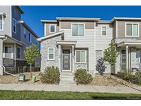 Charming townhouse with stone accents, well-maintained landscaping, and a welcoming entrance at 623 S Pitkin Ct, Aurora, CO 80017