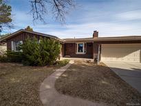 Charming single-story home with a brick exterior, attached garage, and a well-maintained front yard at 1501 E Caley Ave, Centennial, CO 80121