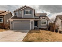 Charming two-story home with a gray exterior, attached garage, and well-maintained lawn at 468 English Sparrow Trl, Highlands Ranch, CO 80129