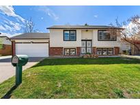Charming two-story home features a well-manicured front lawn and classic curb appeal at 5031 Upton Ct, Denver, CO 80239