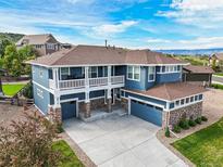 Stunning two-story home featuring a charming balcony, stone accents, and a spacious three-car garage at 5238 Gould Cir, Castle Rock, CO 80109