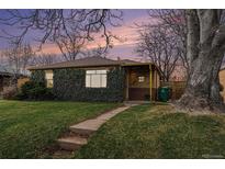 Charming brick home with lush ivy covering the facade and a well-manicured front yard at 2784 W 4Th Ave, Denver, CO 80219