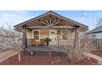 Charming bungalow with a covered porch, decorative wood elements, and inviting curb appeal at 3912 S Acoma St, Englewood, CO 80110