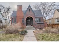 Charming brick home featuring a barrel arch entryway and gabled roof at 265 S Pennsylvania St, Denver, CO 80209