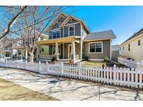 Charming two-story home with a welcoming front porch and white picket fence at 2626 Tamarac St, Denver, CO 80238