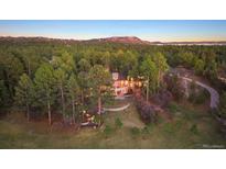 Stunning home surrounded by lush trees, offering privacy and beautiful natural scenery at 67 Indigo Way, Castle Rock, CO 80108