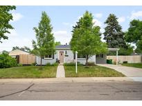 Charming single-story home with a well-maintained lawn, mature trees, and a quaint walkway leading to the front door at 5740 S Cherokee St, Littleton, CO 80120