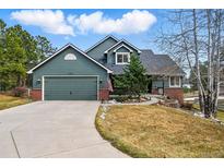 Charming two-story home showcasing a well-maintained yard and a two-car garage at 1330 Conifer Pl, Elizabeth, CO 80107