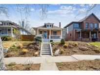 Charming brick home with a cozy front porch and well-manicured front yard at 1074 S Corona St, Denver, CO 80209