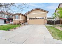 Charming single-Gathering home featuring stone accents, a two-car garage, and a well-maintained front yard at 9844 Norfolk St, Commerce City, CO 80022