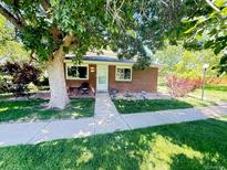 Charming single-story brick home with mature tree in front yard and cozy porch area at 9255 E Lehigh # 213, Denver, CO 80237