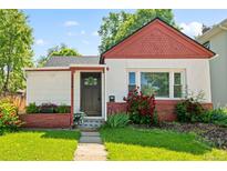 Charming home featuring a well-kept lawn and mature landscaping at 3024 S Sherman St, Englewood, CO 80113