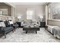 Bright living room featuring neutral colors, large windows, and a stylish rug at 3024 S Sherman St, Englewood, CO 80113