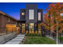Contemporary black home featuring modern design, large windows and professionally landscaped yard at 3709 Tejon St, Denver, CO 80211
