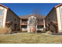 Charming condo building with two stories, private balconies, and well-maintained front lawn at 3282 E 103Rd Dr # 1604, Thornton, CO 80229