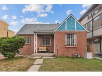 Charming brick home featuring a cozy front porch and well-maintained landscaping at 1425 Xavier St, Denver, CO 80204