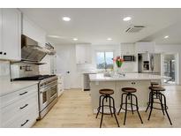 Modern kitchen boasts stainless steel appliances, a large island with seating, and bright, open space at 2166 Appaloosa Trl, Elizabeth, CO 80107