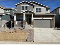 Charming two-story home with stone accents, a welcoming porch, and a two-car garage at 28625 E 6Th Pl, Watkins, CO 80137