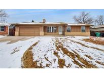 Charming single-story home featuring a spacious front yard with a detached two car garage at 11769 Clayton St, Thornton, CO 80233