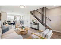 Living room showcasing a modern staircase and comfortable seating at 4336 Decatur St, Denver, CO 80211