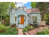 Charming home with light blue siding, arched entryway, and lovely landscaping at 1502 Columbine Ave, Boulder, CO 80302