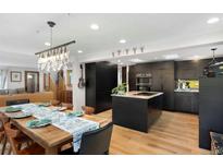 Open kitchen and dining room with a modern island and hardwood floors at 1502 Columbine Ave, Boulder, CO 80302