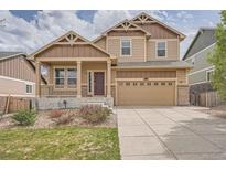 Charming two-story home with a well-manicured lawn, covered porch, and a two-car garage at 24288 E Brandt Ave, Aurora, CO 80016