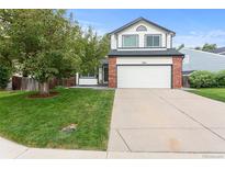 Charming two-story home with a manicured lawn and attached two-car garage at 5494 S Ireland St, Centennial, CO 80015
